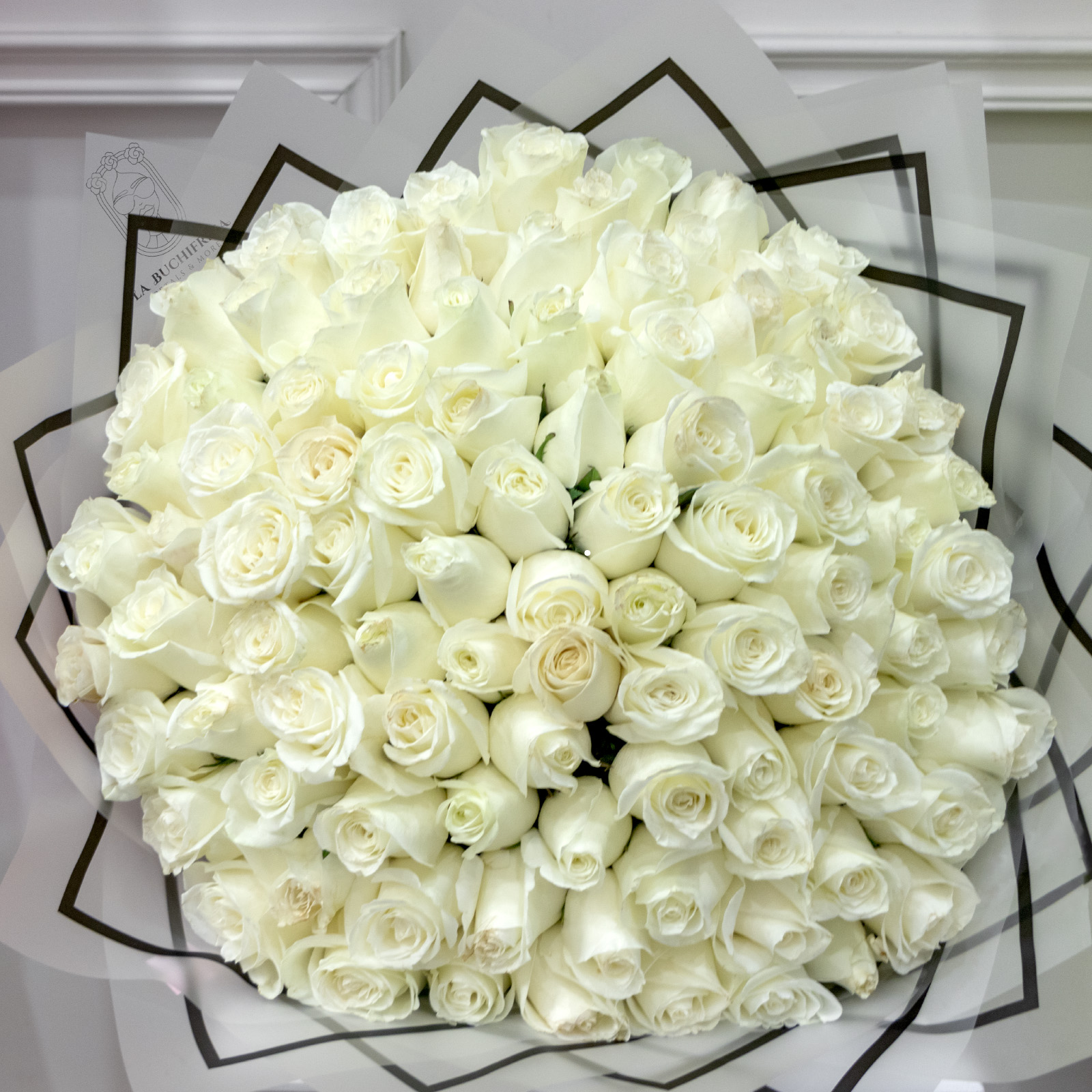 Ramo de 100 rosas blancas premium envuelto en papel coreano y liston