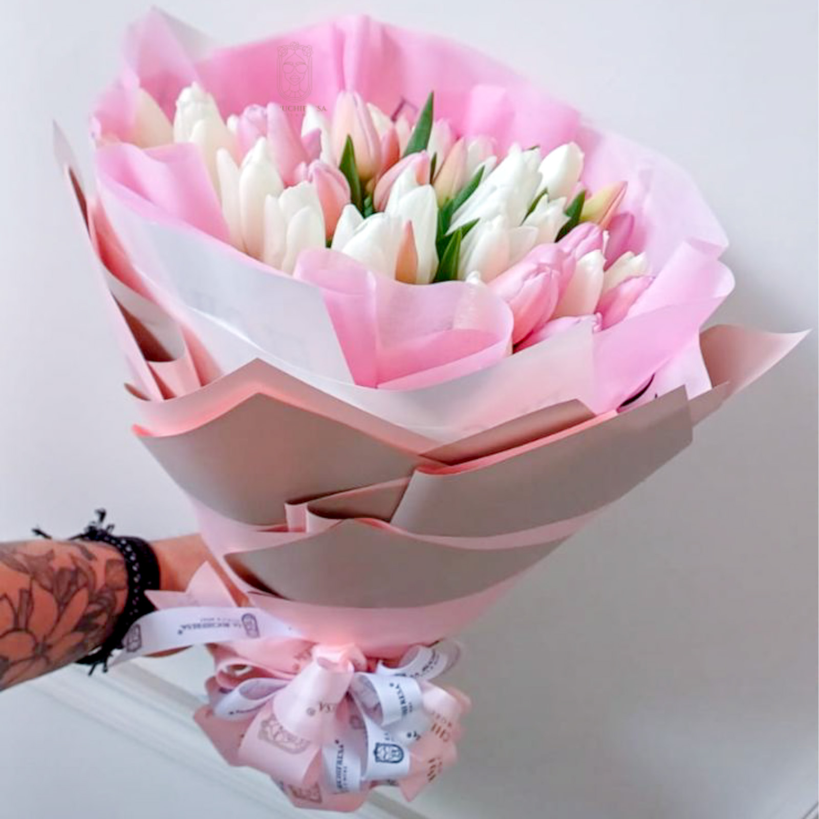 Ramo de 50 tulipanes rosas y blancos envuelto en papel coreano y liston