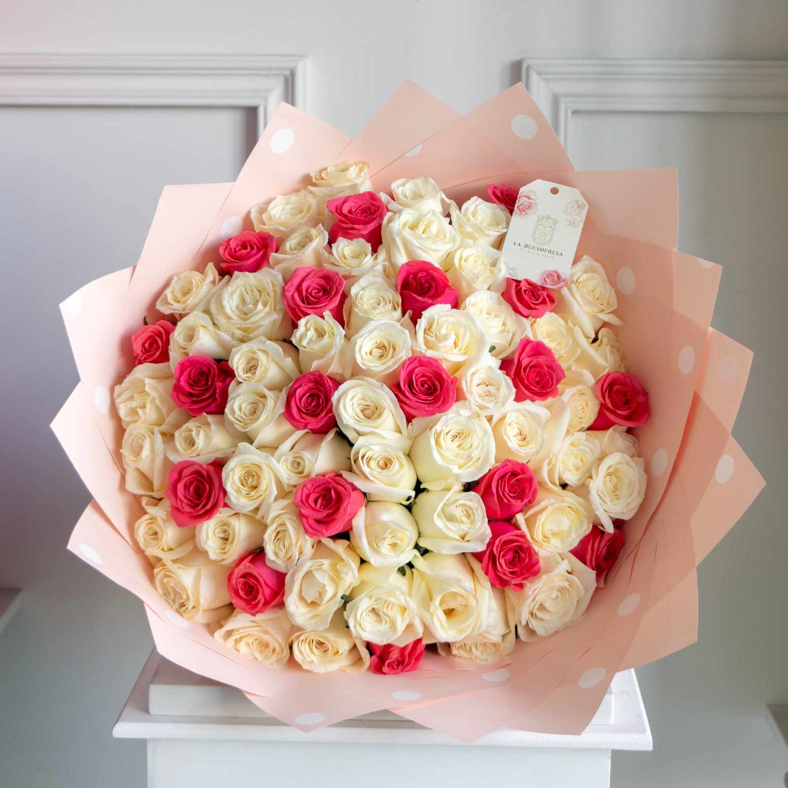 Ramo de 100 rosas blancas con toques de rosas fucsia premium envuelto en papel coreano y liston